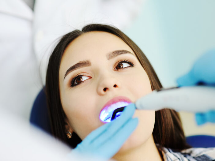 Young-woman-getting-dental-fillings-at-dental-office